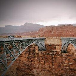 A picture containing building, bridge, sky, mountain
Description automatically generated