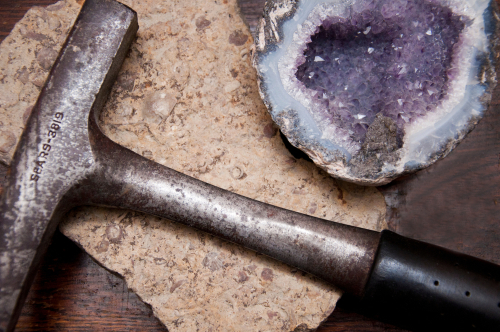 breaking open geode with hammer