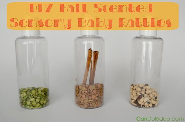 This may contain: three glass bottles filled with different types of spices and herbs in them, all labeled diy fall scented sensory baby rattles