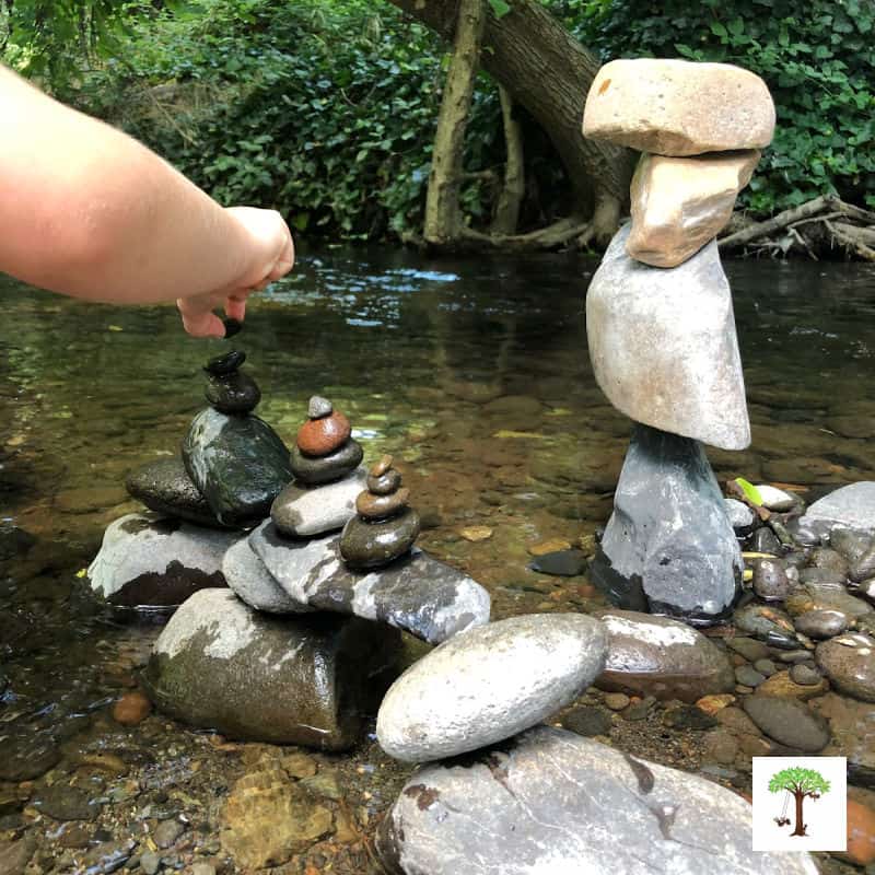 Balancing rocks and building stone stacks and bridges in a shallow part of a creek.