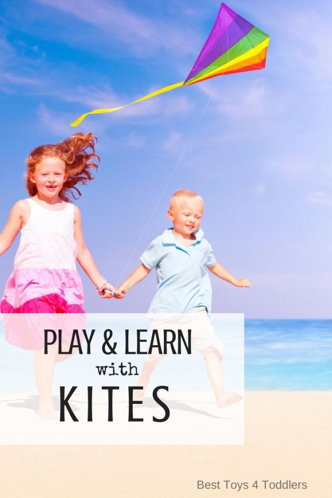 This may contain: two children running on the beach holding hands and flying a kite with text overlay reading play & learn with kites best toys 4 todders