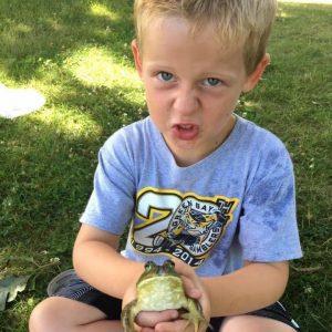 A picture containing grass, person, outdoor, child

Description automatically generated