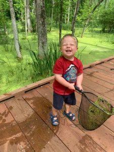 A child holding a snake

Description automatically generated with low confidence