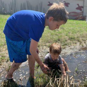 A picture containing grass, outdoor, person, child

Description automatically generated