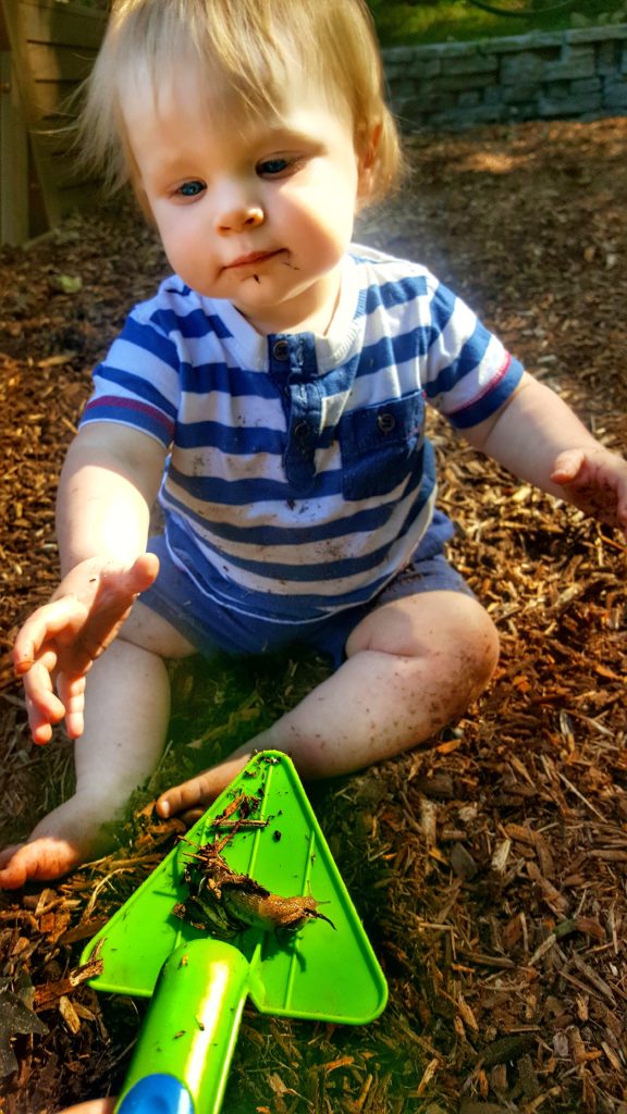 My baby boy going to touch the slug I found in the yard