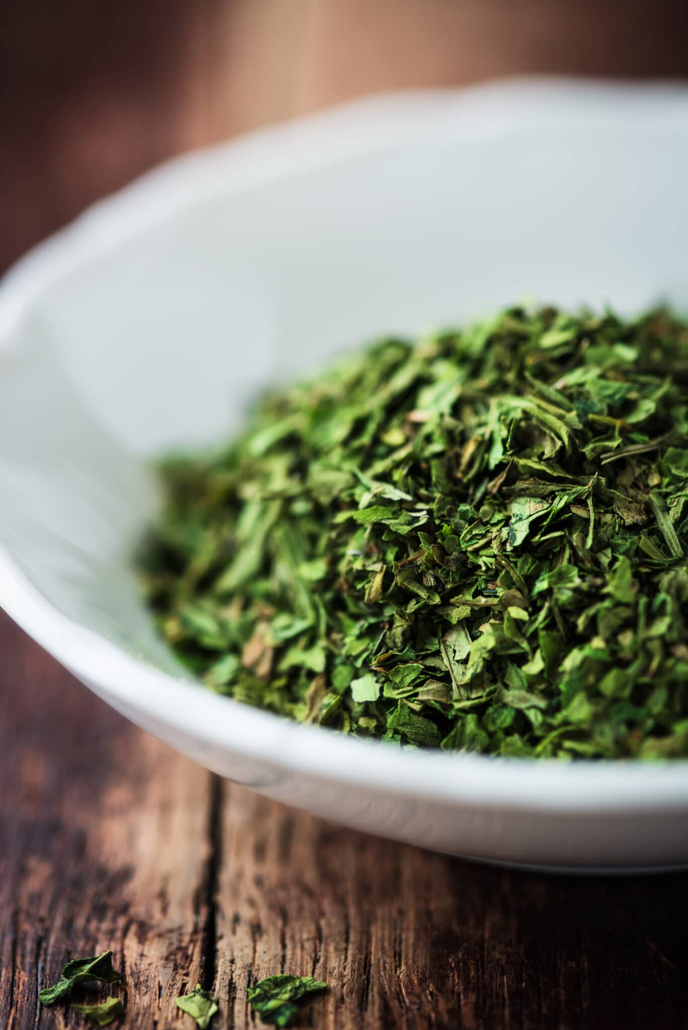 A bowl of freshly chopped lovage in a white bowl.