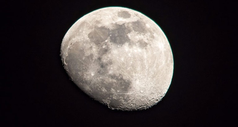 A gibbous moon in the night sky