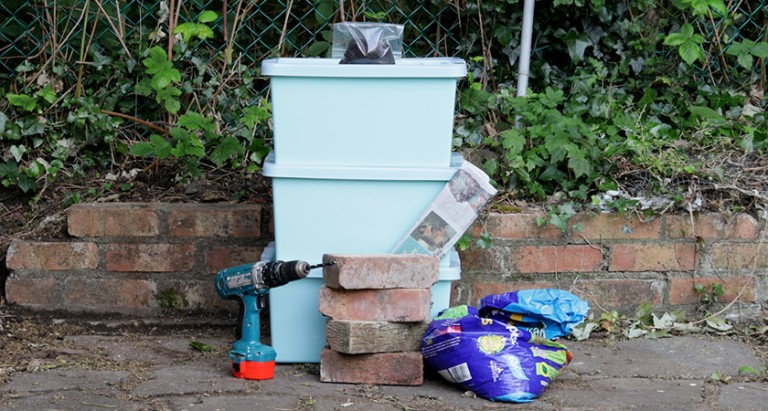 the equipment needed to make a wormery, including boxes, bricks and compost