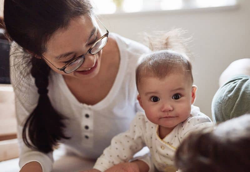 A 3-month-old baby does tummy time activity to play and learn.