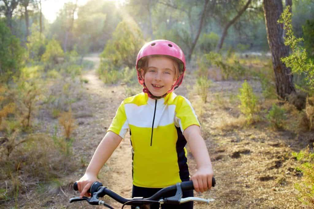 A child wearing a helmet and riding a bike

Description automatically generated with low confidence