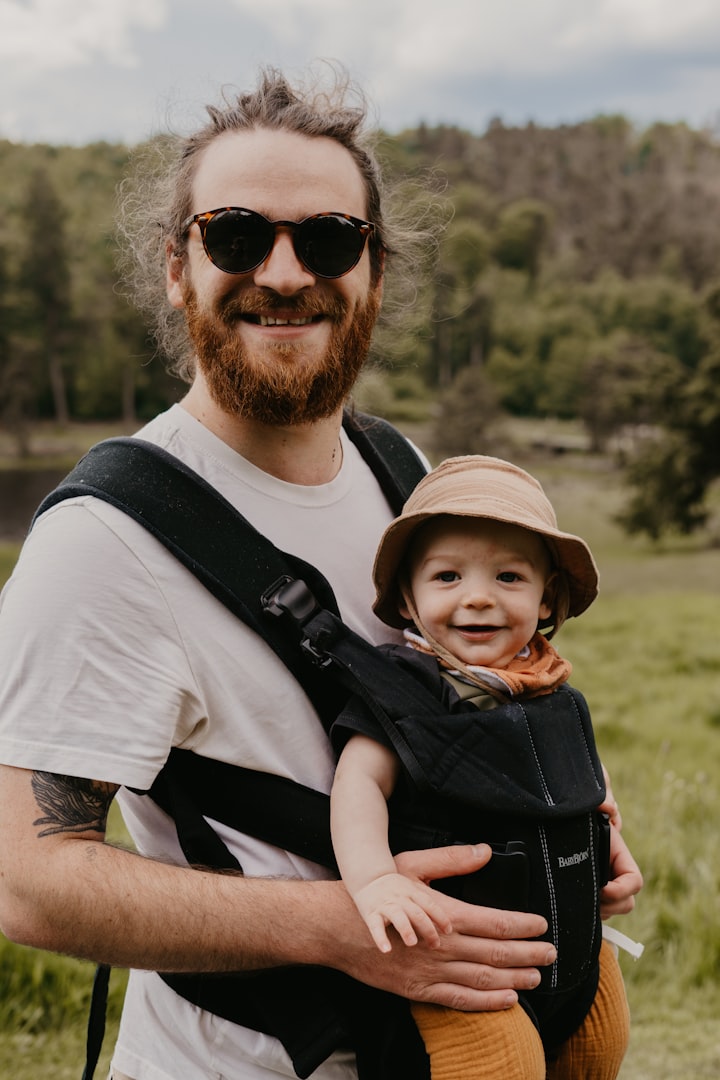 a mom is hiking with a newborn, who is asleep in his baby carrier
