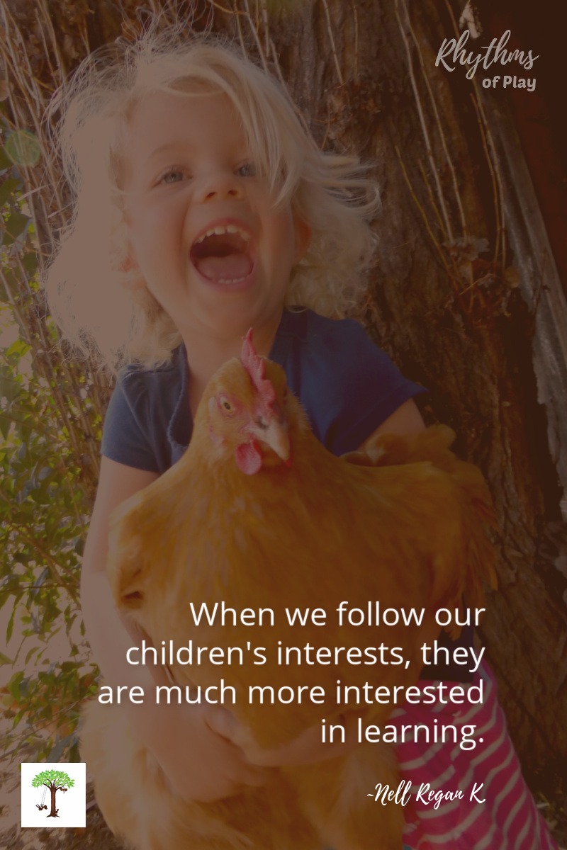 toddler holding a chicken with quote, 