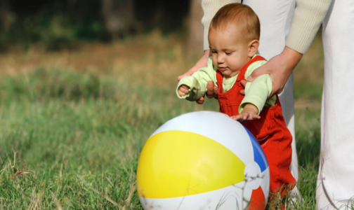 Simple, Quick and Easy Outdoor Activities for Infants by Kirby Crawford for Hike it Baby (image of a mom and her baby girl practicing walking along a beach)