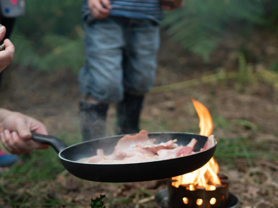 A person cooking food on a grill

Description automatically generated with low confidence