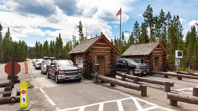 Line of cars at a park entrance station 