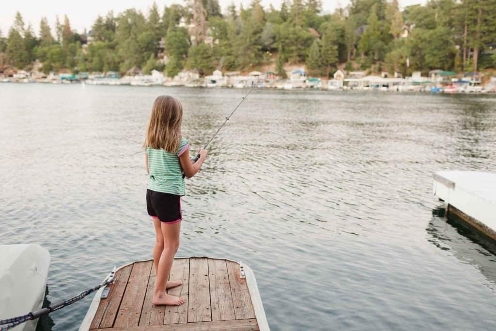 A child fishing on a dock

Description automatically generated with medium confidence